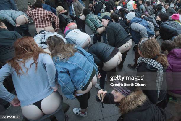 Activists pull down their pants and moon Trump Tower on February 12, 2017 in Chicago, Illinois. The event was staged to protest the policies of...