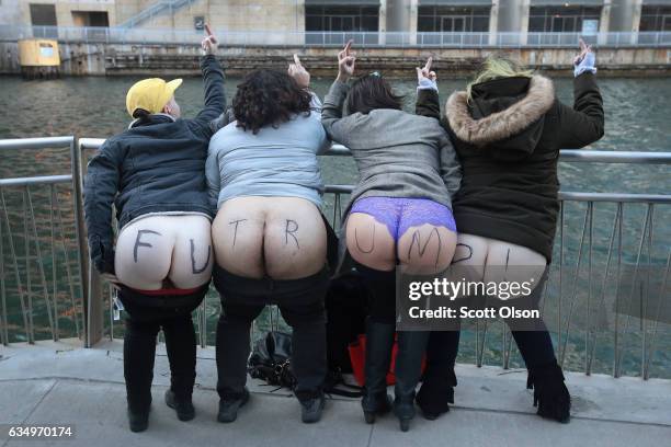 Activists pull down their pants and moon Trump Tower on February 12, 2017 in Chicago, Illinois. The event was staged to protest the policies of...