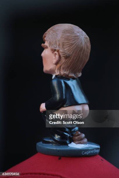Trump figurine sits atop a hat made by Peter Buck which he wore to an event with other activists across from Trump Tower where they pulled down their...