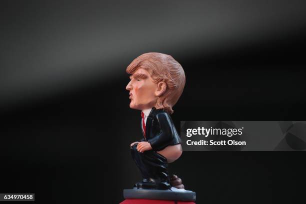 Trump figurine sits atop a hat made by Peter Buck which he wore to an event with other activists across from Trump Tower where they pulled down their...