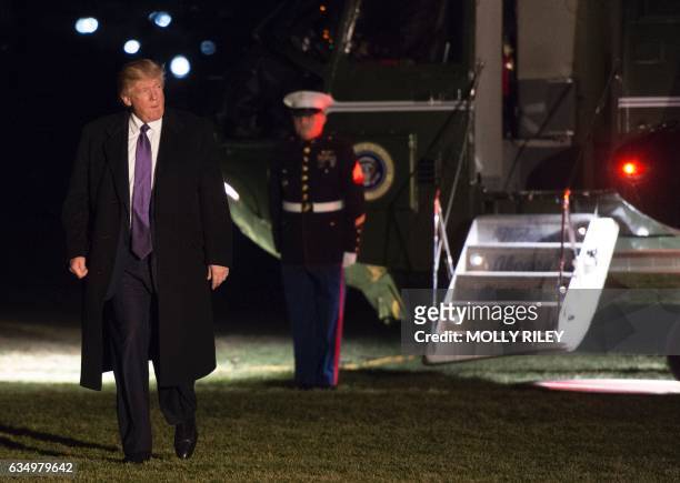 President Donald Trump walks from Marine One on the South Lawn of the White House as he returns from his weekend trip to Mar-a-Lago, on February 12...