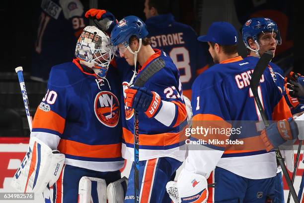 Jean-Francois Berube and Anders Lee of the New York Islanders celebrate after defeating the Colorado Avalanche 5-1 at the Barclays Center on February...