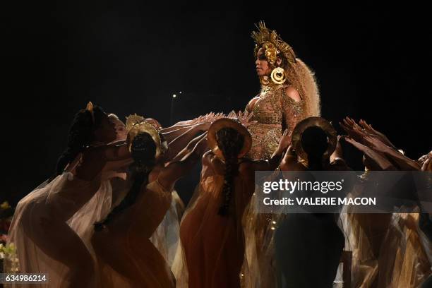 Beyonce performs as she is pregnant with twins during the 59th Annual Grammy music Awards on February 12 in Los Angeles, California.