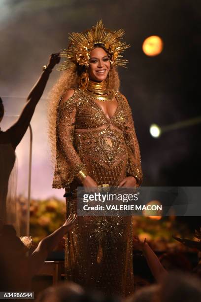 Beyonce performs as she is pregnant with twins during the 59th Annual Grammy music Awards on February 12 in Los Angeles, California. / AFP / VALERIE...