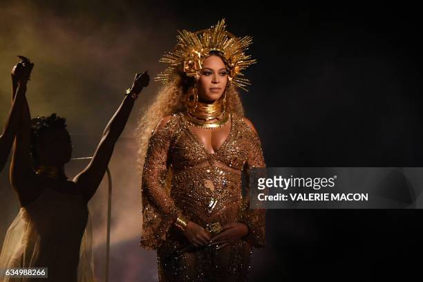 Beyonce performs as she is pregnant with twins during the 59th Annual Grammy music Awards on February 12 in Los Angeles, California. / AFP / VALERIE...