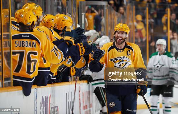 Mike Fisher of the Nashville Predators celebrates his empty net goal with the bench against the Dallas Stars during an NHL game at Bridgestone Arena...