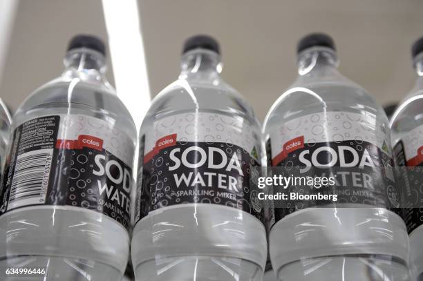 Bottles of store brand brand soda water sit on a shelf at a Coles supermarket, operated by Wesfarmers Ltd., in the Richmond area of Melbourne,...