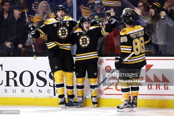 Frank Vatrano of the Boston Bruins celebrates with Zdeno Chara and David Pastrnak after scoring against the Montreal Canadiens at TD Garden on...