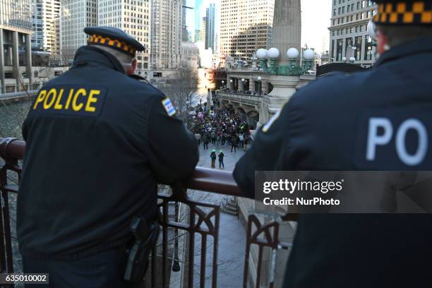 Police guard the front of activists gather across from Trump Tower before pulling down their pants and mooning on February 12, 2017 in Chicago,...