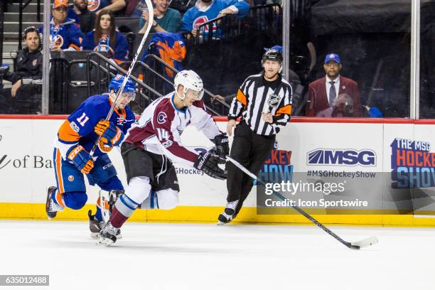 Colorado Avalanche Left Wing Blake Comeau works past New York Islanders Right Wing Shane Prince during the first period of a regular season NHL game...