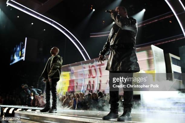 Hip-hop artists Consequence and Busta Rhymes perform with A Tribe Called Quest onstage during The 59th GRAMMY Awards at STAPLES Center on February...