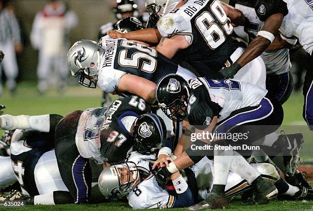 Rob Murphy and Jason Chorak of the Chicago Enforcers team up to take down Tommy Maddox of the Los Angeles Xtreme during the game at the L.A. Coliseum...