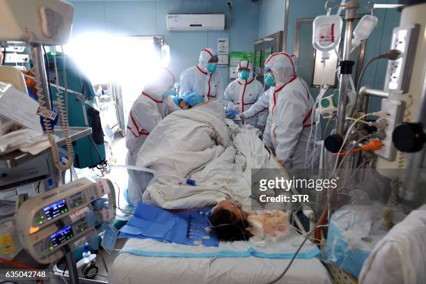 This photo taken on February 12, 2017 shows an H7N9 bird flu patient being treated in a hospital in Wuhan, central China's Hubei province. A number...
