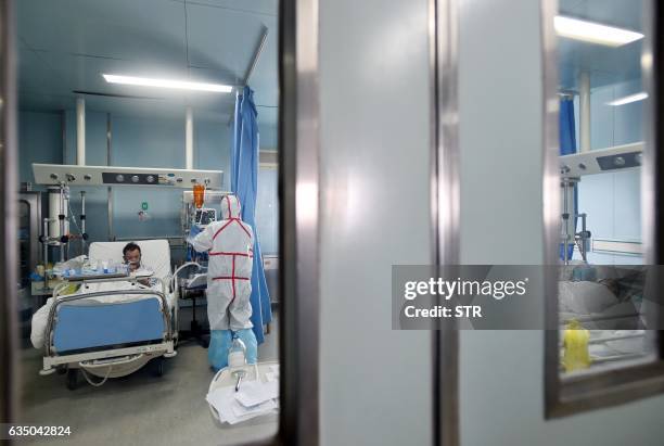 This photo taken on February 12, 2017 shows H7N9 bird flu patients lying in their beds after being treated in a hospital in Wuhan, central China's...