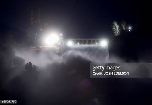 This long exposure photograph shows the Oroville Dam discharging water at a rate of 100,000 cubic feet per second over a spillway as an emergency...