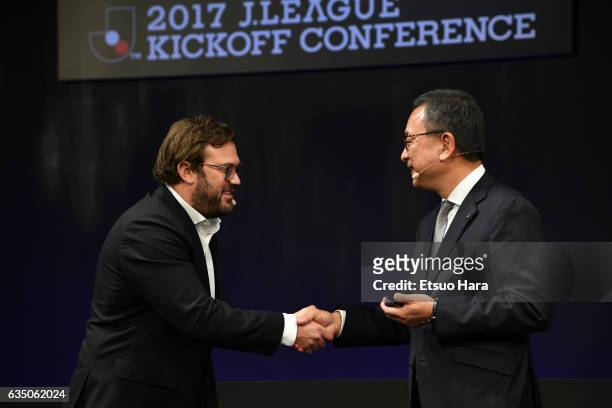 James Rushton shakes hands with J.League Chairman Mitsuru Murai during the J.League Kick Off Conference at Tokyo International Forum on February 13,...
