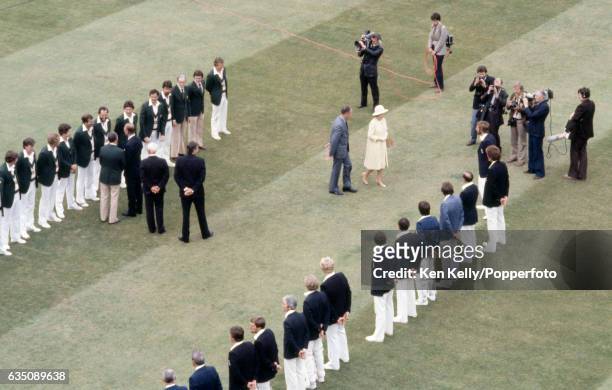 The Queen is accompanied by MCC president Peter May to meet England captain Ian Botham and the rest of the England team during the 2nd Test match...