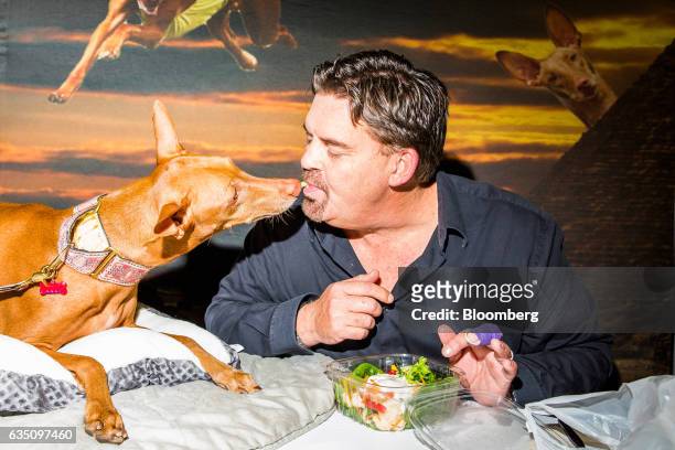 Dog owner and his Pharoh Hound dog share a vegetable during the annual Meet the Breed event ahead of the 141st Westminster Kennel Club Dog Show in...