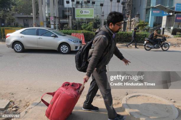 Man going home by walking due to app-based cab strike, on February 13, 2017 in Gurgaon, India. Starting as a driver centric market where cab...