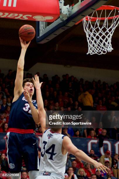 Gonzaga Bulldogs forward Zach Collins shoots over St. Mary's Gaels center Jock Landale during the first half of the Gaels' 74-64 loss to the...