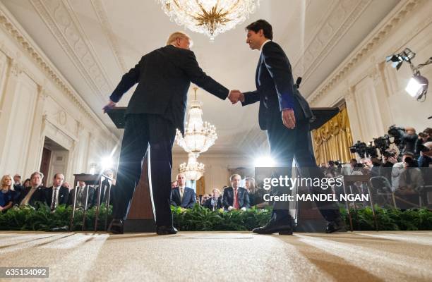 President Donald Trump and Canada's Prime Minister Justin Trudeau shake hands during a joint press conference in the East Room of the White House on...