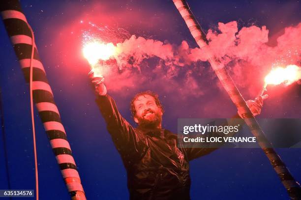 French skipper Eric Bellion celebrates aboard his Imoca 60 "Comme un seul Homme" as he arrives at Les Sables d'Olonne after placing 9th of the Vendee...