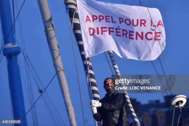 French skipper Eric Bellion celebrates aboard his Imoca 60 "Comme un seul Homme" as he arrives at Les Sables d'Olonne after placing 9th of the Vendee...