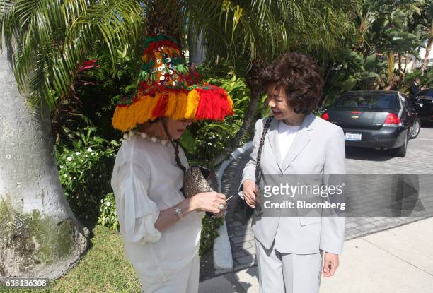 Peggy Siegal and Elaine Chao stand outside the Brazilian Court hotel in Palm Beach, Florida, U.S., on Saturday, Feb. 11, 2017. There were camels in...