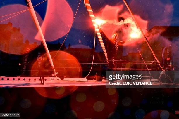 French skipper Eric Bellion celebrates aboard his Imoca 60 "Comme un seul Homme" as he arrives at Les Sables d'Olonne after placing 9th of the Vendee...