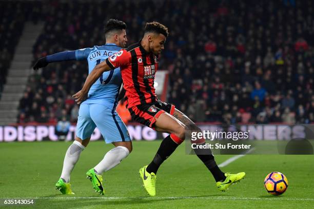 Tyrone Mings of Bournemouth battles for the ball with Sergio Aguero of Manchester City during the Premier League match between AFC Bournemouth and...