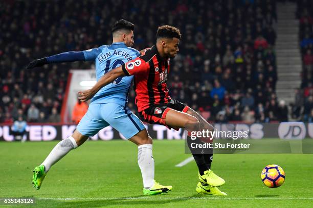 Tyrone Mings of Bournemouth battles for the ball with Sergio Aguero of Manchester City during the Premier League match between AFC Bournemouth and...