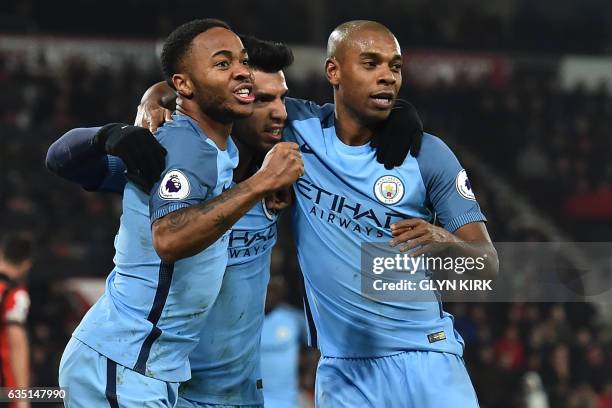 Manchester City's Argentinian striker Sergio Aguero celebrates with Manchester City's English midfielder Raheem Sterling and Manchester City's...