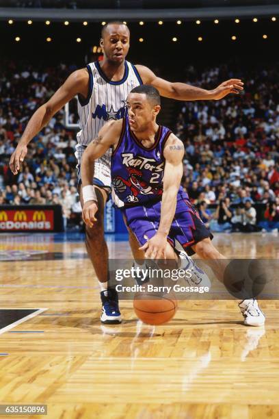 Damon Stoudamire of the Toronto Raptors drives against Brian Shaw of the Orlando Magic on January 3, 1996 at the Orlando Arena in Orlando, Florida....