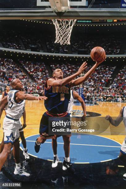 Jalen Rose of the Denver Nuggets shoots against the Orlando Magic on December 14, 1994 at the Orlando Arena in Orlando, Florida. NOTE TO USER: User...