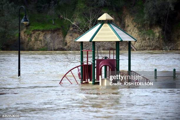 Playground is seen submerged in flowing water at Riverbend Park as the Oroville Dam releases water down the spillway in Oroville, California on...