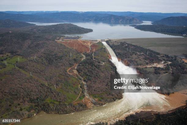 Oroville lake, the emergency spillway, and the damaged main spillway, are seen from the air on February 13, 2017 in Oroville, California. The erosion...