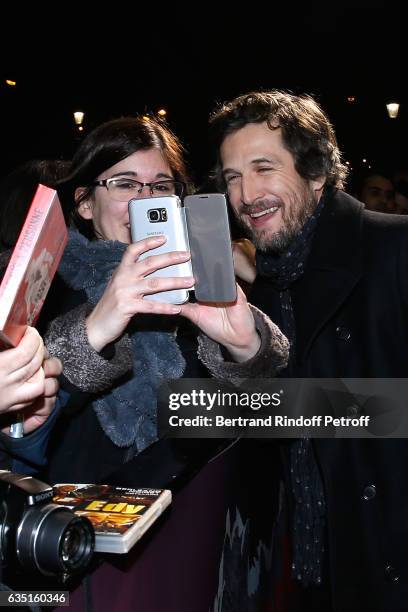 Actor and Director of the movie Guillaume Canet signs autographs arriving at the "Rock'N Roll" Premiere at Cinema Pathe Beaugrenelle on February 13,...