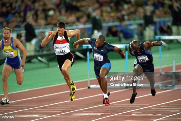 Florian Schwarthoff of Germany, Mark Creer of the USA, and Allen Johnson of the USA run in the Men's 110m Hurdles Event during the Sydney 2000...