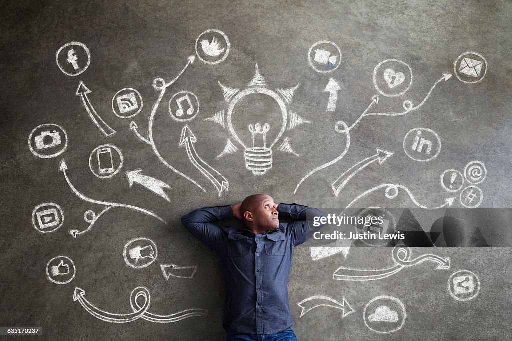 African Man, 30s, Surrounded by Chalkboard Symbols