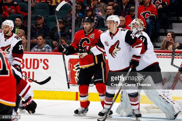Troy Brouwer of the Calgary Flames skates against Michael Stone of the Arizona Coyotes during an NHL game on February 13, 2017 at the Scotiabank...