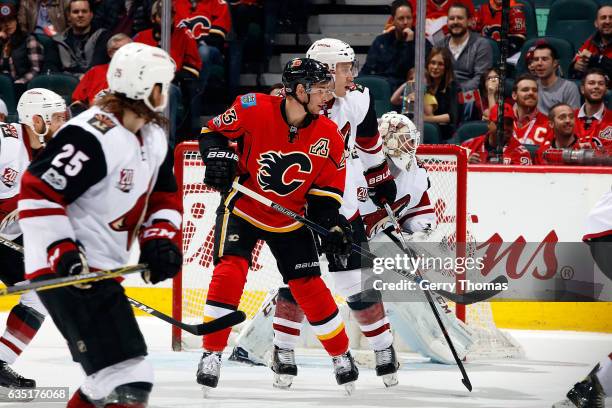 Sean Monahan of the Calgary Flames skates against Michael Stone of the Arizona Coyotes during an NHL game on February 13, 2017 at the Scotiabank...
