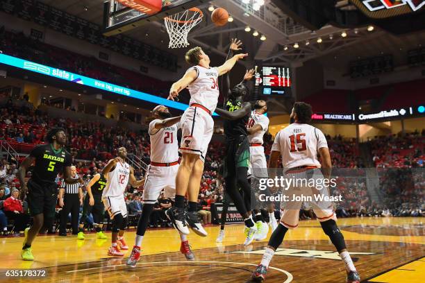 Jo Lual-Acuil Jr. #0 of the Baylor Bears shoots the ball over Matthew Temple of the Texas Tech Red Raiders during the game on February 13, 2017 at...