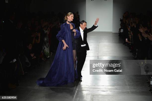 Fashion designer Zang Toi and a model walk the runway for the Zang Toi collection during, New York Fashion Week: The Shows at Pier 59 on February 13,...