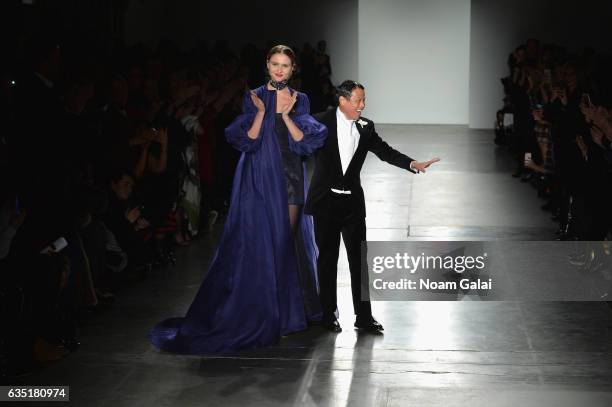 Fashion designer Zang Toi and a model walk the runway for the Zang Toi collection during, New York Fashion Week: The Shows at Pier 59 on February 13,...