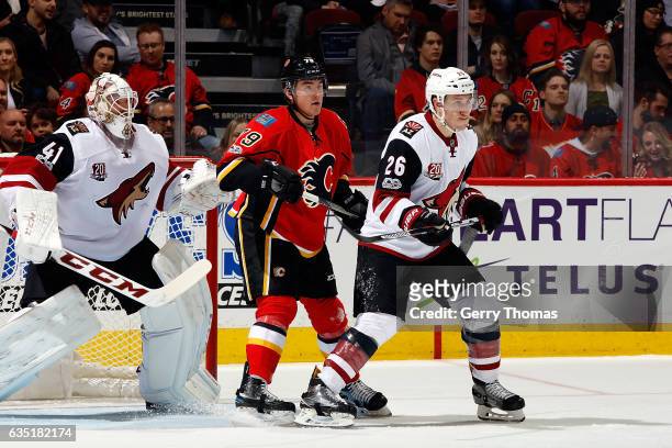 Micheal Ferland of the Calgary Flames skates against Michael Stone of the Arizona Coyotes during an NHL game on February 13, 2017 at the Scotiabank...