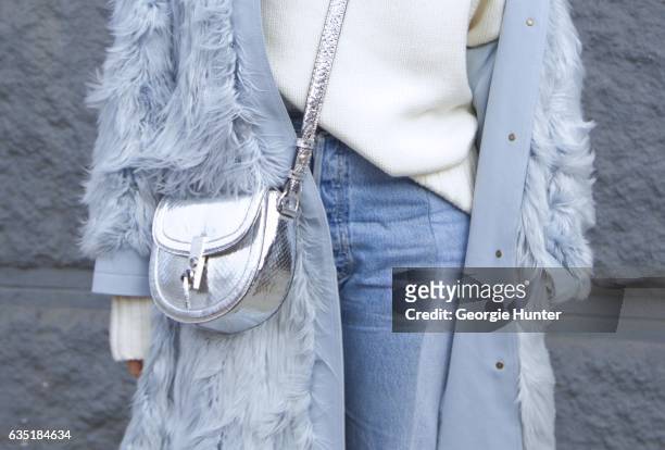 Tiffany Hsu is seen at Spring Studios outside the Phillip Lim show wearing three quarter length pastel blue faux fur coat, denim jeans with frayed...