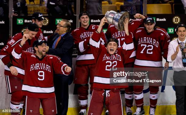 Devin Tringale of the Harvard Crimson celebrates with his teammates after beating the Boston University Terriers during NCAA hockey in the...