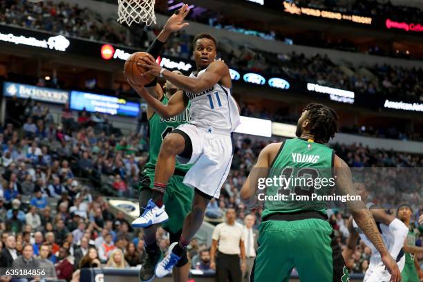 Yogi Ferrell of the Dallas Mavericks passes the ball against Al Horford of the Boston Celtics and James Young of the Boston Celtics in the second...