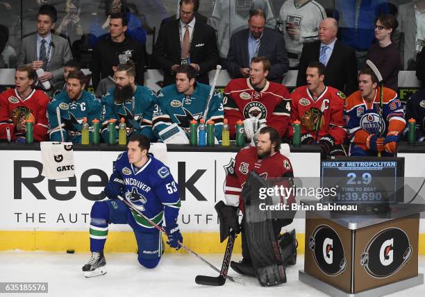 Bo Horvat of the Vancouver Canucks and Mike Smith of the Arizona Coyotes kneel on the ice during the Gatorade Skills Challenge Relay as part of the...