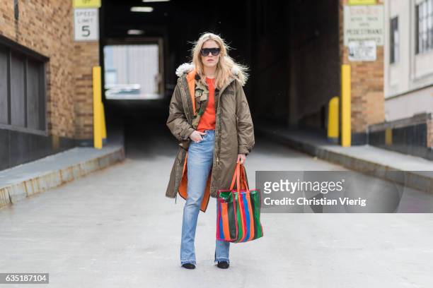 Annabel Rosendahl wearing parka, denim jeans, Balenciaga bag outside Proenza Schouler on February 13, 2017 in New York City.